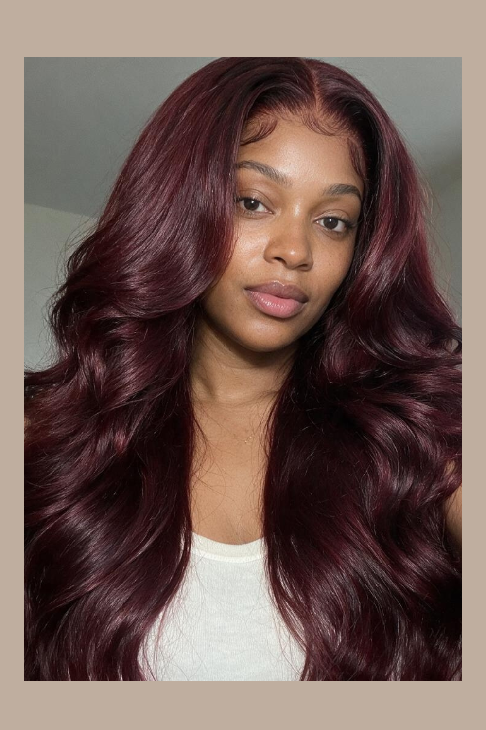 Model wearing the Noor 99J burgundy body wave 13x4 HD lace front wig, chest length