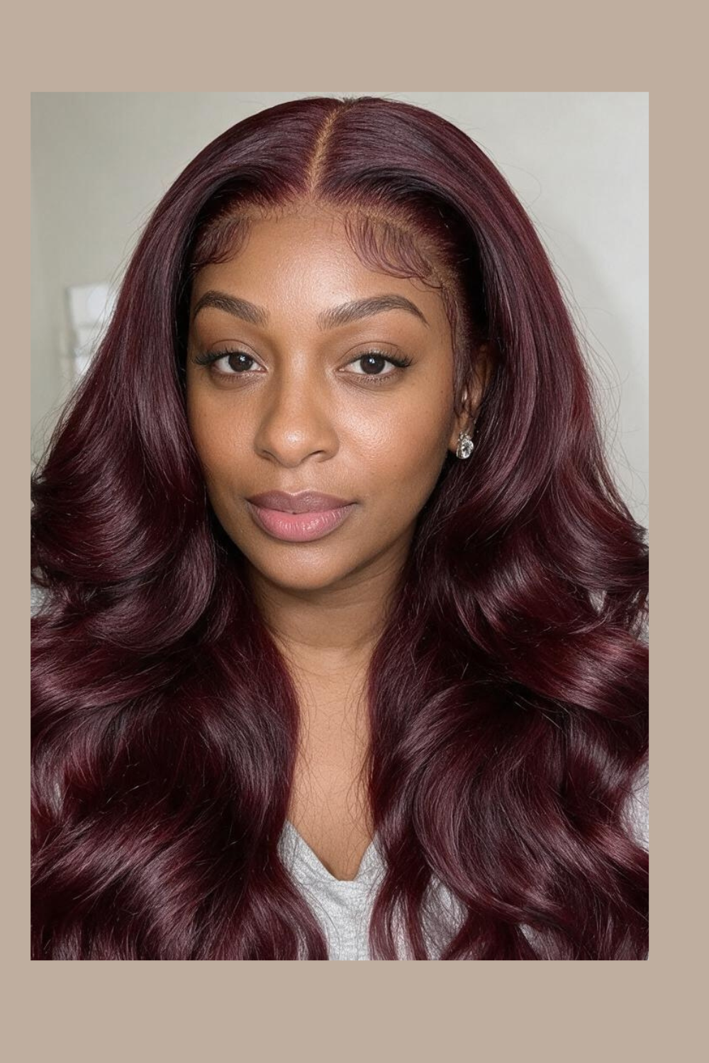 Front view of the Noor 99J burgundy wig with a middle part and loose body wave curls